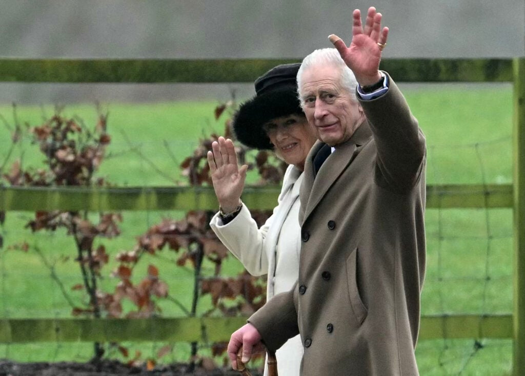 King Charles and Camilla wave during a walk in early 2024.