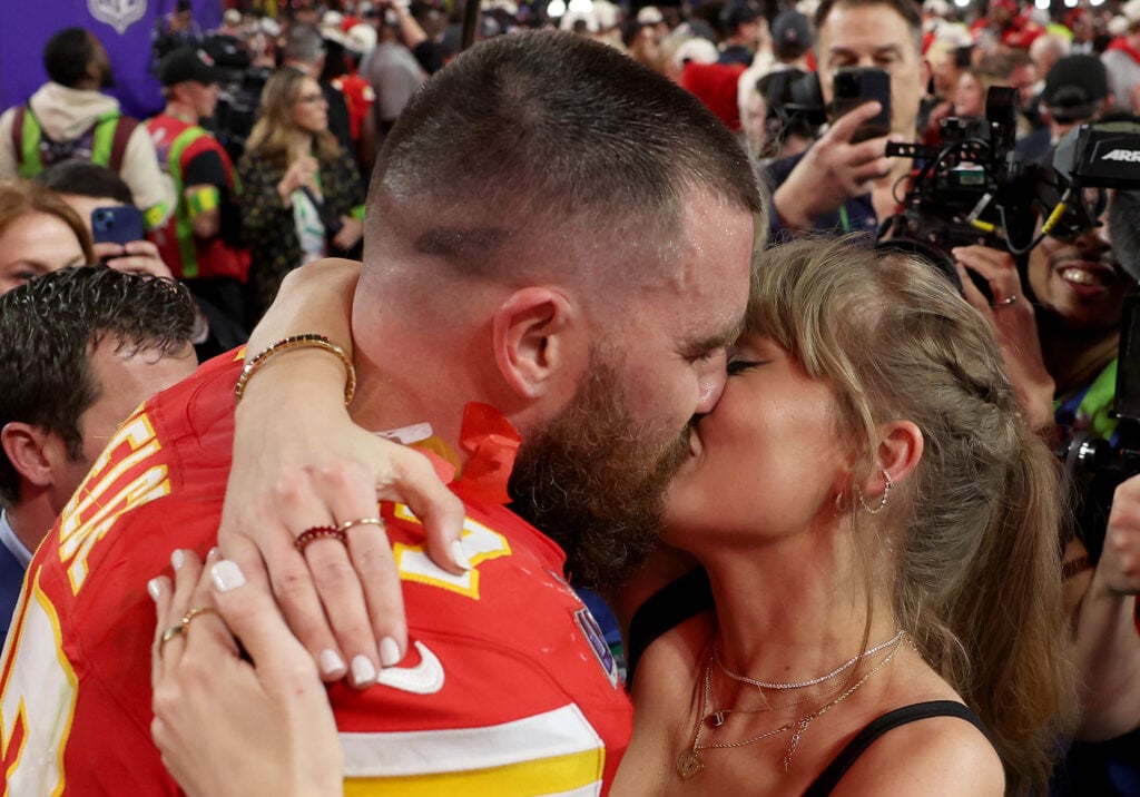 Taylor Swift and Travis Kelce in February 2024, on the field at the Super Bowl.