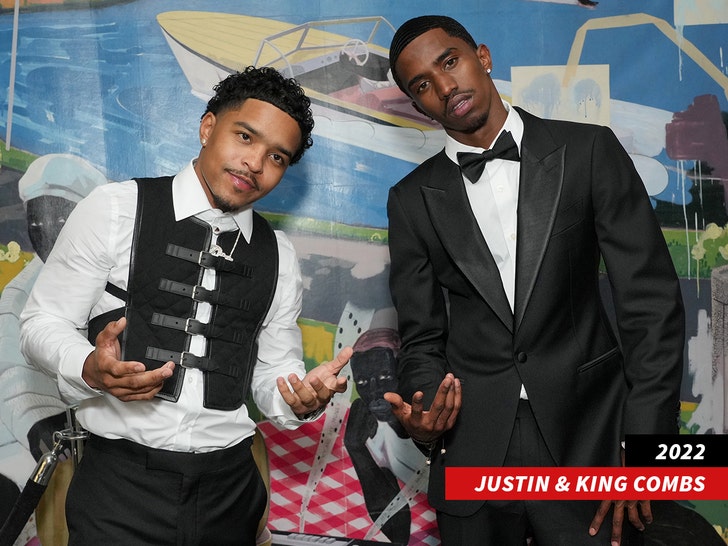 Justin and King Combs in black ties leaning in while looking at the camera.