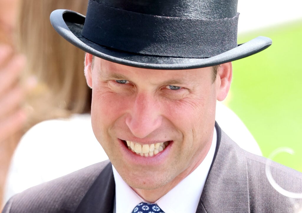 Prince William smiles awkwardly in an absurd hat in June 2024.