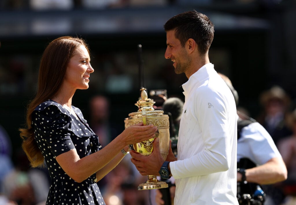 Catherine, Duchess of Cambridge, presents the trophy to winner Novak Djokovic of Serbia following his victory against Nick Kyrgios of Australia during the men's singles final on day fourteen of the 2022 Wimbledon Championships. 