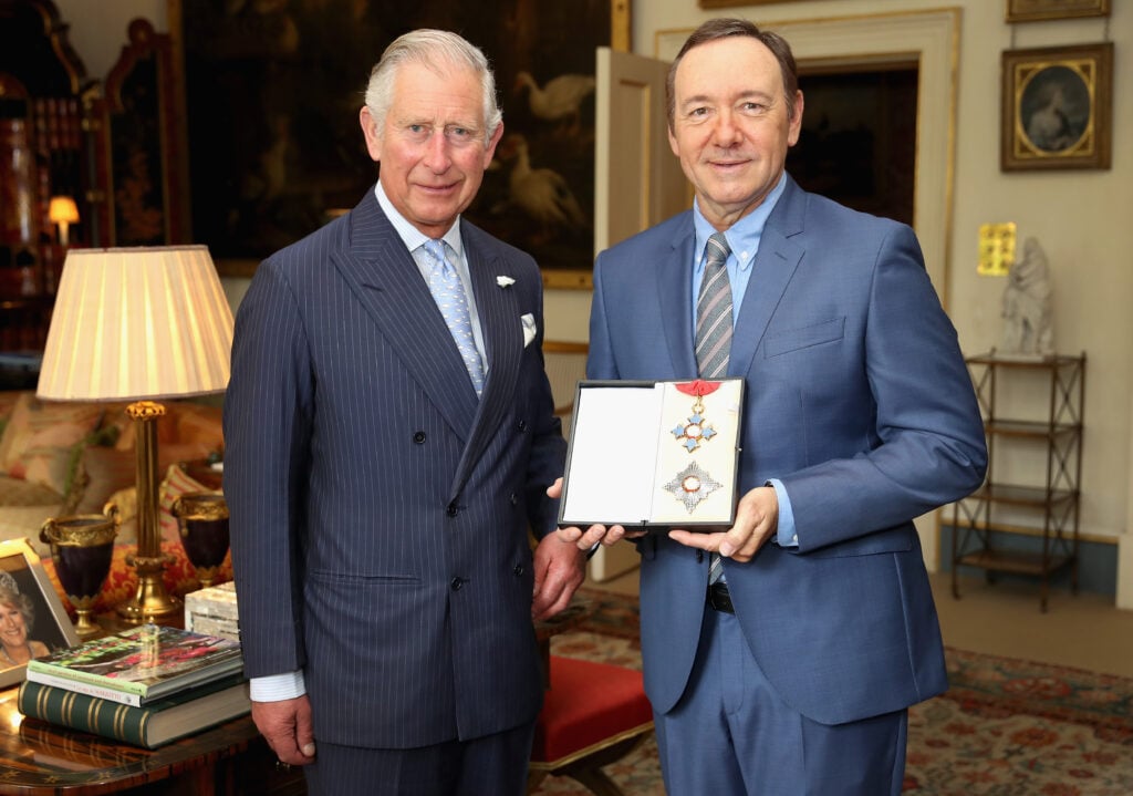 Prince Charles, Prince of Wales, presents actor Kevin Spacey with his honorary KBE for services to theatre, arts education and international culture at Clarence House on June 16, 2016 in London, England.  