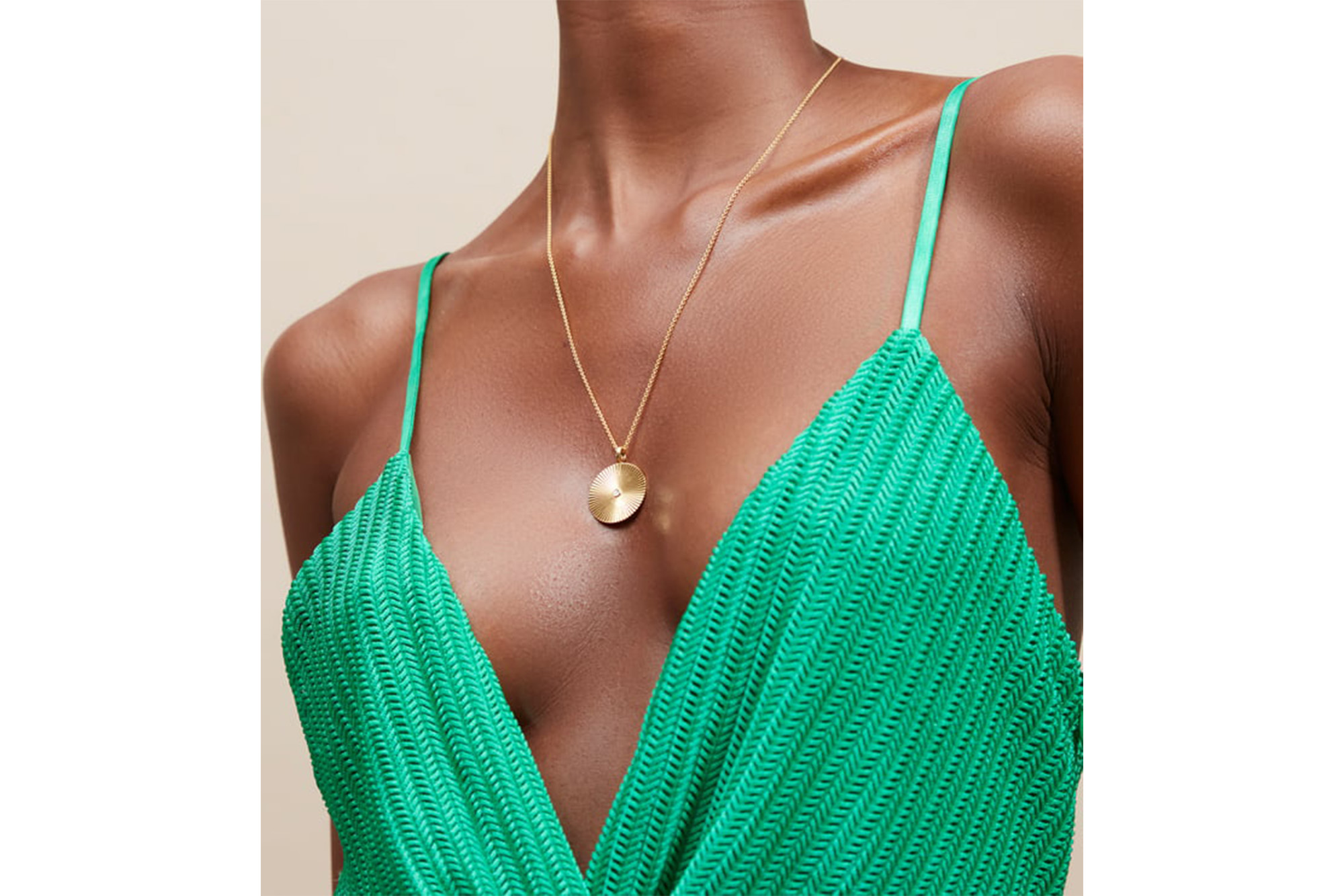 A model with a gold necklace