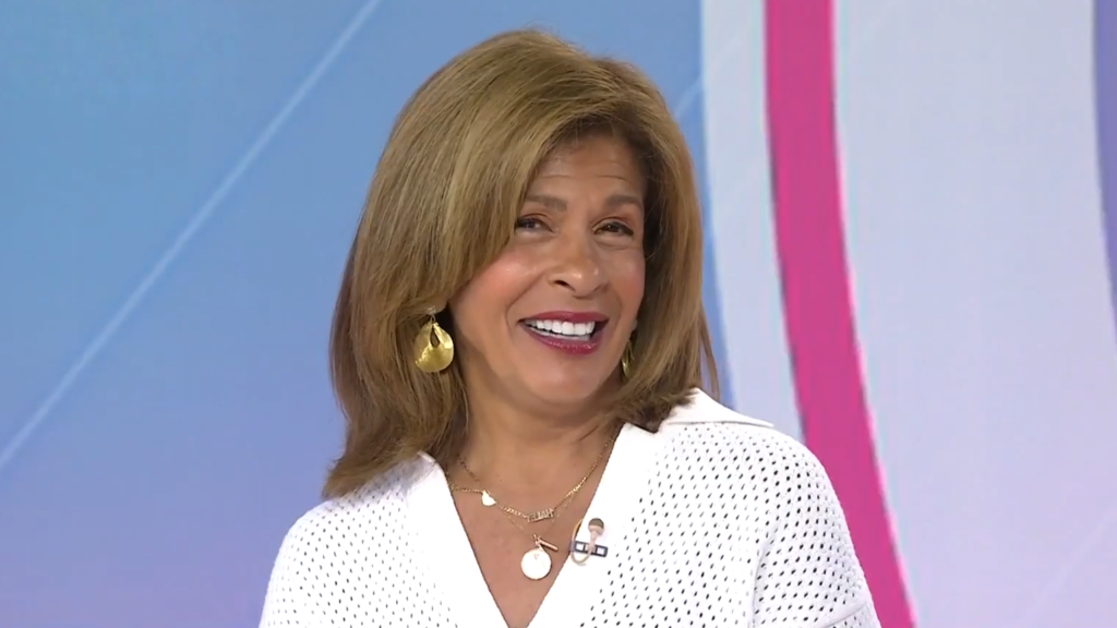 Hoda Kotb smiles shyly and appears to blush.