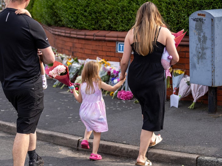 Flowers at the scene where children were stabbed and killed during Taylor Swift's themed party