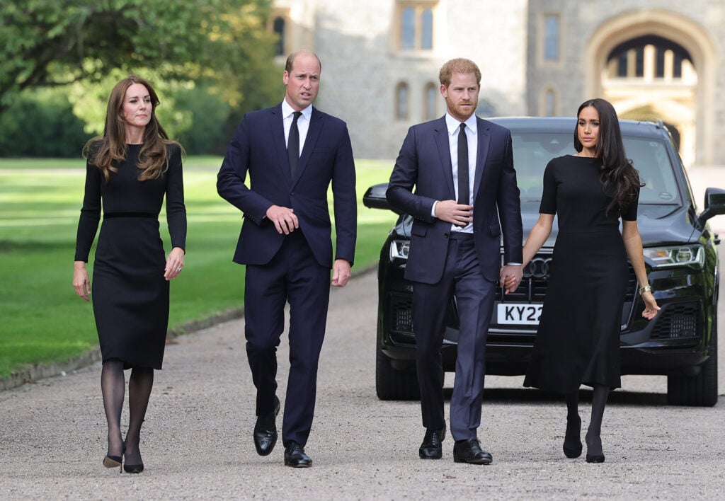 Catherine, Princess of Wales, Prince William, Prince of Wales, Prince Harry, Duke of Sussex, and Meghan, Duchess of Sussex, on the Long Walk at Windsor Castle, arrive to view flowers and tributes to Queen Elizabeth on September 10, 2022 in Windsor, England. 