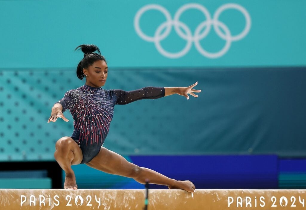     Simone Biles of Team USA practices on the balance beam during a gymnastics training session at Bercy Arena ahead of the Paris 2024 Olympic Games on July 25, 2024 in Paris, France. 