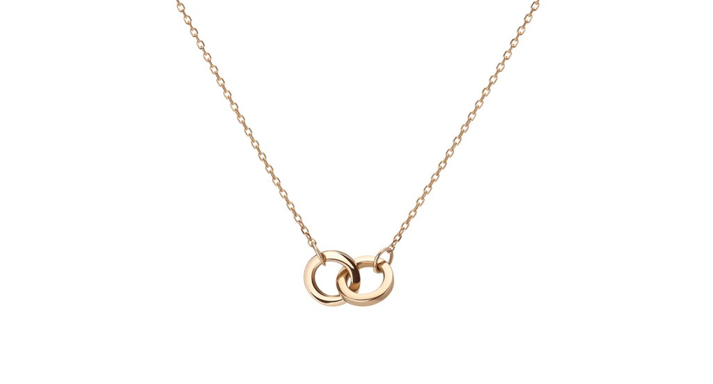 A gold necklace with an intertwined pendant