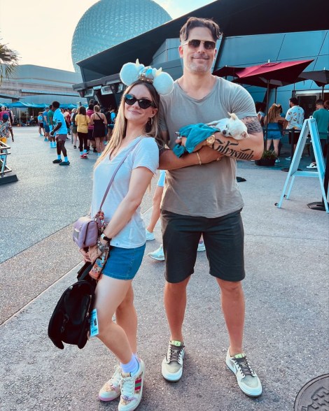 joe manganiello holding a dog next to his girlfriend caitlin o'connor