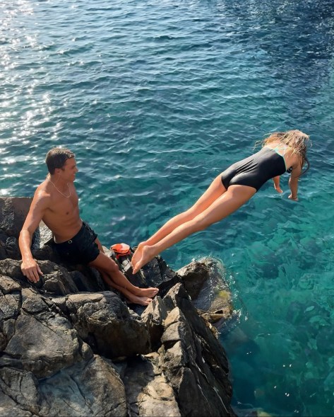 ENJOYING THE DAY: Tom Brady watches as 11-year-old daughter Vivian dives into the end zone.