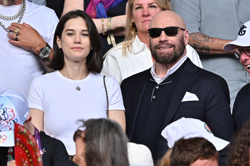 RACQUET GANG: John Travolta and his daughter Ella, 24, are paying close attention to the men's tennis final at the Paris Olympics.