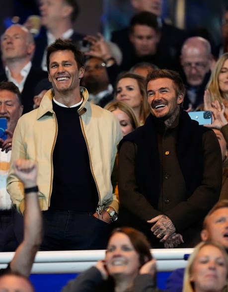 POINT GUYS: Tom Brady (left) and David Beckham laugh before a soccer match in Birmingham, England.