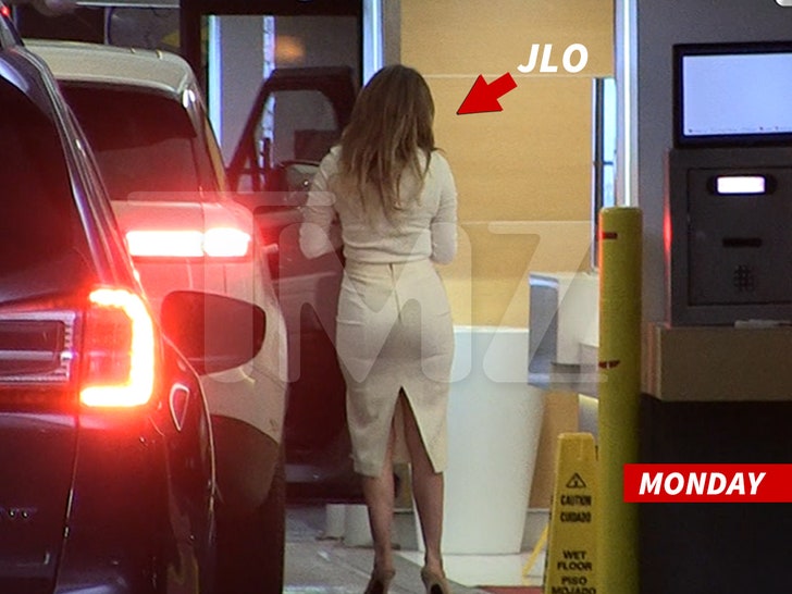 Jennifer Lopez exiting a car in a parking lot on her way to Ben Affleck's divorce negotiations.