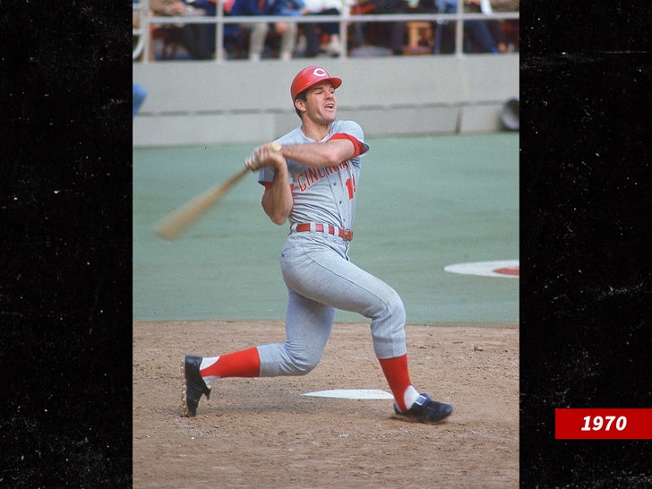 Pete Rose at base, in gray uniform, on the end of a left-handed hit.