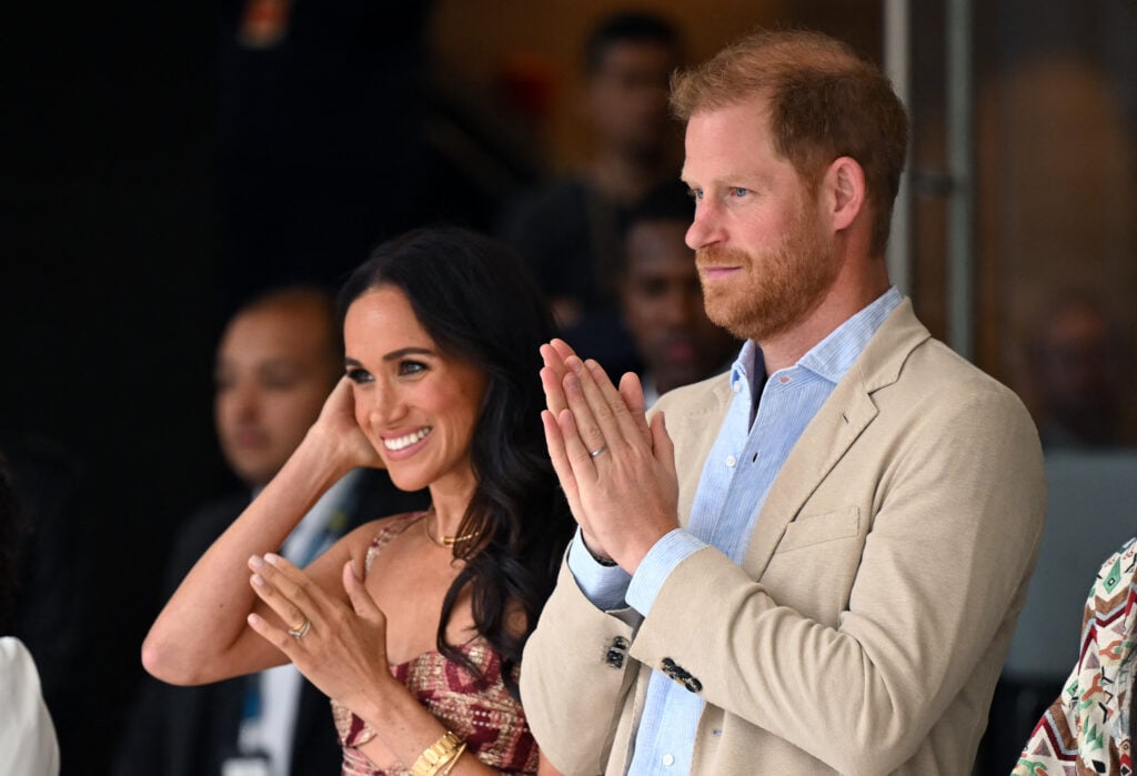 Britain's Prince Harry, Duke of Sussex, and his wife Meghan Markle react while watching a show during a visit to the National Arts Center in Bogota on August 15, 2024. 